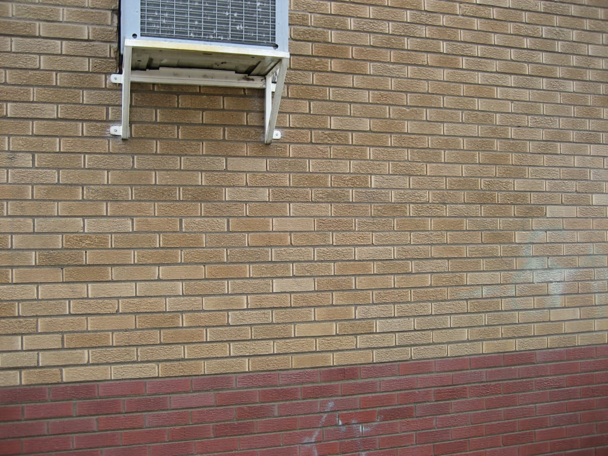 The same brickwork after removal, the surface clean with no shadow of the tag remaining